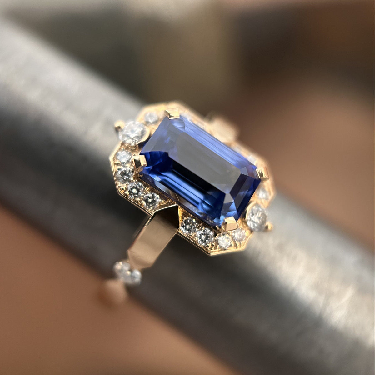 Détail d'une bague de fiançailles en or rose avec saphir bleu naturel et diamants